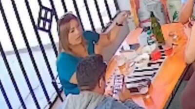 The footage shows Helenn Guilianna Silva Padilla seated at a table with two men and another woman when